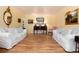 Bright living room featuring hardwood floors, classic furnishings, and ample natural light at 10366 E Ida Ave, Greenwood Village, CO 80111