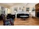 Cozy living room with a brick fireplace, vaulted ceilings, wood paneling, and plentiful natural light at 10366 E Ida Ave, Greenwood Village, CO 80111