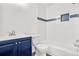 Updated bathroom with a navy vanity, white subway tile, and a bathtub at 1811 S Quebec Way # 151, Denver, CO 80231