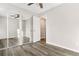 Spacious bedroom with mirrored closet doors and vinyl wood flooring at 1811 S Quebec Way # 151, Denver, CO 80231