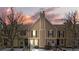 Tan-colored townhome exterior with a charming front entrance and landscaping at 1811 S Quebec Way # 151, Denver, CO 80231