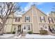 Beige two story townhome with snow in front at 1811 S Quebec Way # 151, Denver, CO 80231