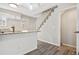Modern kitchen with white cabinets, granite countertops, and a breakfast bar at 1811 S Quebec Way # 151, Denver, CO 80231