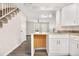 Updated kitchen boasts white cabinets and a granite countertop island at 1811 S Quebec Way # 151, Denver, CO 80231