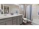 Bright bathroom featuring a double vanity and a shower-tub combo at 3011 Low Meadow Blvd, Castle Rock, CO 80109