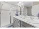 Bright bathroom with double sink vanity and tiled walk-in shower at 3011 Low Meadow Blvd, Castle Rock, CO 80109