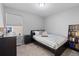 Cozy bedroom with dark furniture, comfortable bed, and a bookshelf at 3011 Low Meadow Blvd, Castle Rock, CO 80109