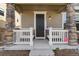 Inviting covered front porch with white railing and decorative stone pillars provides a warm welcome at 3011 Low Meadow Blvd, Castle Rock, CO 80109