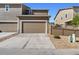 Attached two-car garage with brown garage door at 3011 Low Meadow Blvd, Castle Rock, CO 80109
