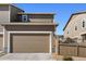 Attached two-car garage with brown garage door at 3011 Low Meadow Blvd, Castle Rock, CO 80109