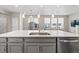 Spacious kitchen island featuring a sink, dishwasher and generous counter space at 3011 Low Meadow Blvd, Castle Rock, CO 80109