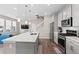Modern open-concept kitchen featuring a large island, stainless steel appliances, and stylish gray cabinetry at 3011 Low Meadow Blvd, Castle Rock, CO 80109