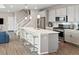 Modern kitchen featuring an island with bar seating, stainless appliances, and open floor plan at 3011 Low Meadow Blvd, Castle Rock, CO 80109