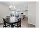 Open layout with dining area connected to a kitchen featuring an island with barstool seating and hardwood floors at 3011 Low Meadow Blvd, Castle Rock, CO 80109