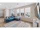 Cozy living room showcases natural light, plush blue sectional sofa with throw pillows, and a patterned rug at 3011 Low Meadow Blvd, Castle Rock, CO 80109