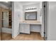 Bright bathroom with white cabinets, light countertop, and a shower with a sliding glass door at 2879 S Xanadu Way, Aurora, CO 80014