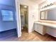 Bathroom with a well-lit vanity and a door to a shower area at 2879 S Xanadu Way, Aurora, CO 80014