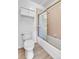 A well-lit bathroom featuring a toilet and a bathtub with sliding glass doors at 2879 S Xanadu Way, Aurora, CO 80014