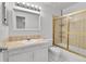 Bright bathroom featuring a shower-tub combo with sliding doors and a white vanity at 2879 S Xanadu Way, Aurora, CO 80014