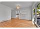 Bright dining room featuring hardwood floors, classic chandelier and sliding doors to deck at 2879 S Xanadu Way, Aurora, CO 80014