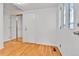 Bright entryway with gleaming hardwood floors and mirrored closet doors at 2879 S Xanadu Way, Aurora, CO 80014