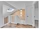 Hallway with skylight and modern chandelier leading to a door at 2879 S Xanadu Way, Aurora, CO 80014