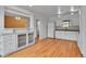 Open floorplan shows kitchen featuring white cabinets and hardwood floors at 2879 S Xanadu Way, Aurora, CO 80014