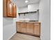 Basement kitchenette area features cabinetry, countertop, sink, and range hood at 2879 S Xanadu Way, Aurora, CO 80014