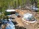 Unique geodesic dome and garage near a blue plow truck surrounded by wooded scenery at 456 Copperdale Ln, Golden, CO 80403