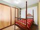 Bedroom with unique terra cotta flooring and a decorative wooden four poster bed at 456 Copperdale Ln, Golden, CO 80403