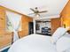 Bedroom featuring wood paneled walls, closet with built-ins, and a large window with natural light at 456 Copperdale Ln, Golden, CO 80403