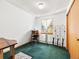 Bright bedroom featuring a desk, green carpet, and a decorative metal screen at 456 Copperdale Ln, Golden, CO 80403