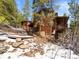 Exterior view of the cabin-style house with lush surrounding trees at 456 Copperdale Ln, Golden, CO 80403