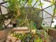 Interior shot of the greenhouse filled with colorful flowers, lush plants, and abundant vegetation at 456 Copperdale Ln, Golden, CO 80403