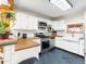 Kitchen with white cabinets, butcher block countertops, subway tile backsplash, and stainless steel appliances at 456 Copperdale Ln, Golden, CO 80403