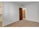 Bright bedroom featuring neutral carpet, white walls, and a closet with ample storage space at 2335 E Cherrywood Dr, Lafayette, CO 80026