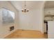 Bright dining area with hardwood floors, a modern chandelier, and a large window providing natural light at 2335 E Cherrywood Dr, Lafayette, CO 80026