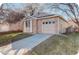 Charming single-story home featuring a brick facade, attached garage, well-maintained lawn, and inviting curb appeal at 2335 E Cherrywood Dr, Lafayette, CO 80026