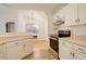 Efficient kitchen features white cabinets, stainless steel appliances, and a view into the dining area at 2335 E Cherrywood Dr, Lafayette, CO 80026
