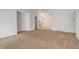 Open floor plan showcasing the living room, dining area, and staircase with neutral carpet and light walls at 2335 E Cherrywood Dr, Lafayette, CO 80026