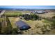 Aerial image showcasing a large building surrounded by trees, near city infrastructure, highlighting its natural and urban access at 12518 N Dixon Dr, Parker, CO 80138