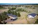 Aerial view of the home with outbuilding, surrounded by trees, on a sprawling green lot at 12518 N Dixon Dr, Parker, CO 80138