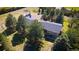 Aerial view showing the home situated amongst mature trees on a picturesque lot at 12518 N Dixon Dr, Parker, CO 80138