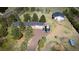 Aerial view of the home and large outbuilding nestled on a large lot with mature landscaping and a long driveway at 12518 N Dixon Dr, Parker, CO 80138