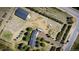 Aerial view of a property featuring multiple structures and landscaping, highlighting the layout and surrounding land at 12518 N Dixon Dr, Parker, CO 80138