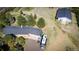 Expansive aerial view of a ranch-style home with large outbuilding surrounded by a beautifully wooded landscape at 12518 N Dixon Dr, Parker, CO 80138
