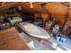 Spacious barn interior featuring a boat, car lift, shelves, and ample storage space at 12518 N Dixon Dr, Parker, CO 80138