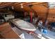 This barn interior shows a boat, car lift, shelving units, and ample storage space at 12518 N Dixon Dr, Parker, CO 80138