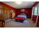 Cozy bedroom with carpet, bright red walls, and a large window for plenty of natural light at 12518 N Dixon Dr, Parker, CO 80138