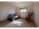 Relaxing bedroom with carpet, natural light, and a comfortable rocking chair at 12518 N Dixon Dr, Parker, CO 80138